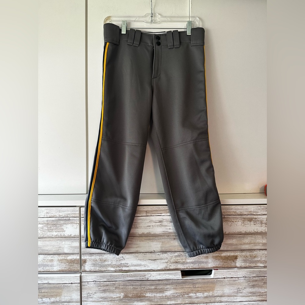 ⚾ Mizuno Performance women’s softball pants in gray with yellow side stripes.